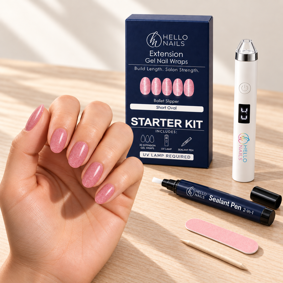 Extension Gel Starter Kit - Ballet Slipper hero - hand with short oval ballet pink shimmer nails, kit box and contents