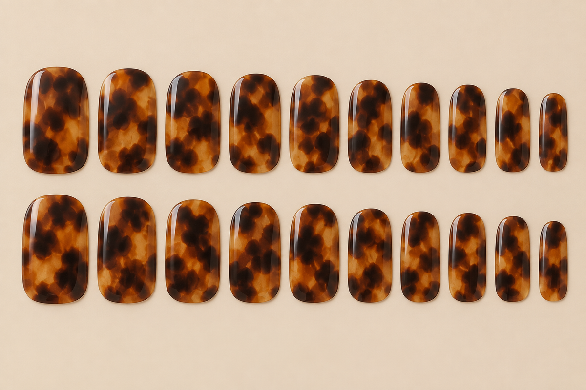 Tortoise shell nail wraps flat lay in warm brown and amber tones